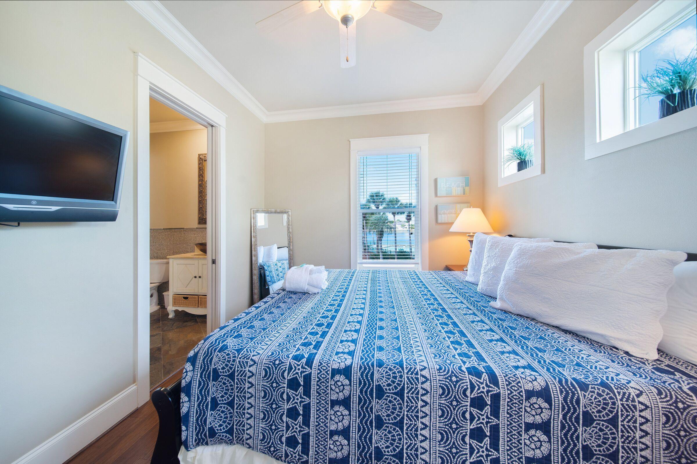 4836 Ocean Boulevard Destin, FL 32541 - Photo 52 of 71 a bedroom with a large bed and a flat screen tv