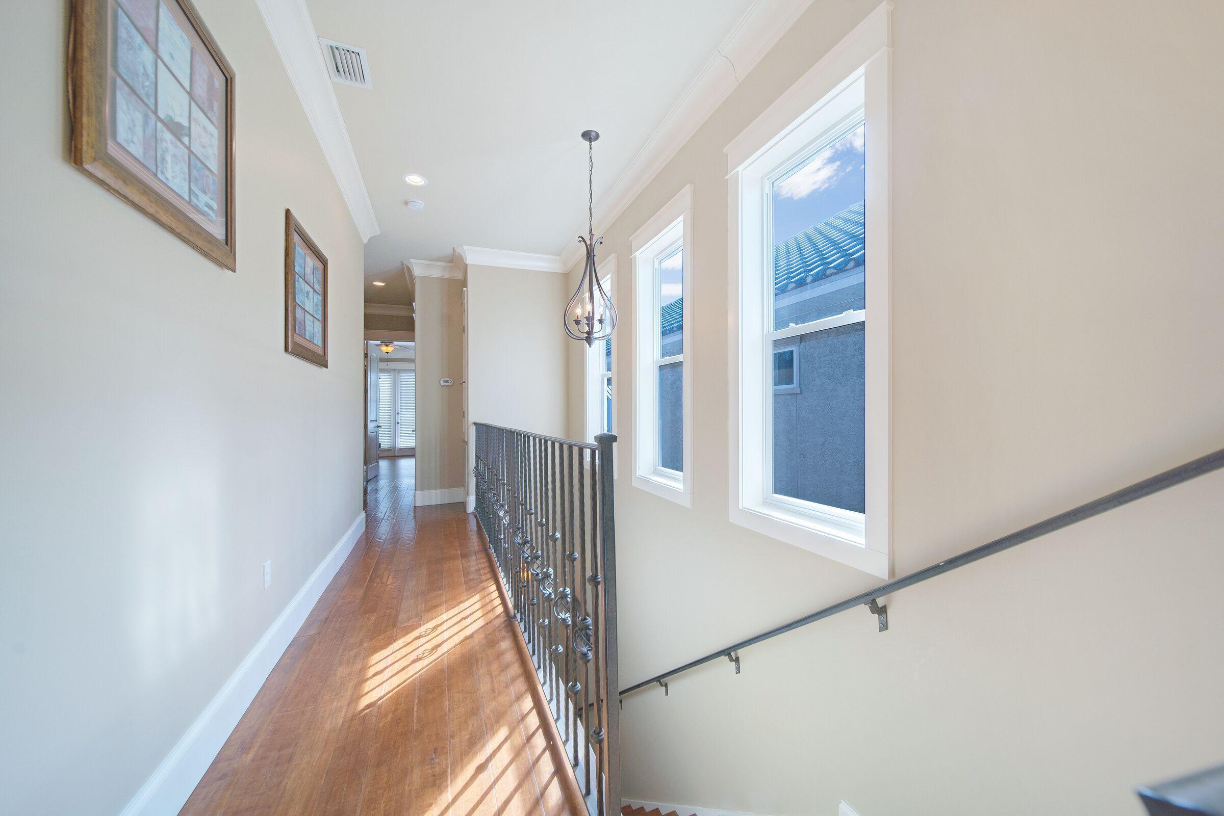 4836 Ocean Boulevard Destin, FL 32541 - Photo 55 of 71 a view of a hallway with wooden floor and staircase