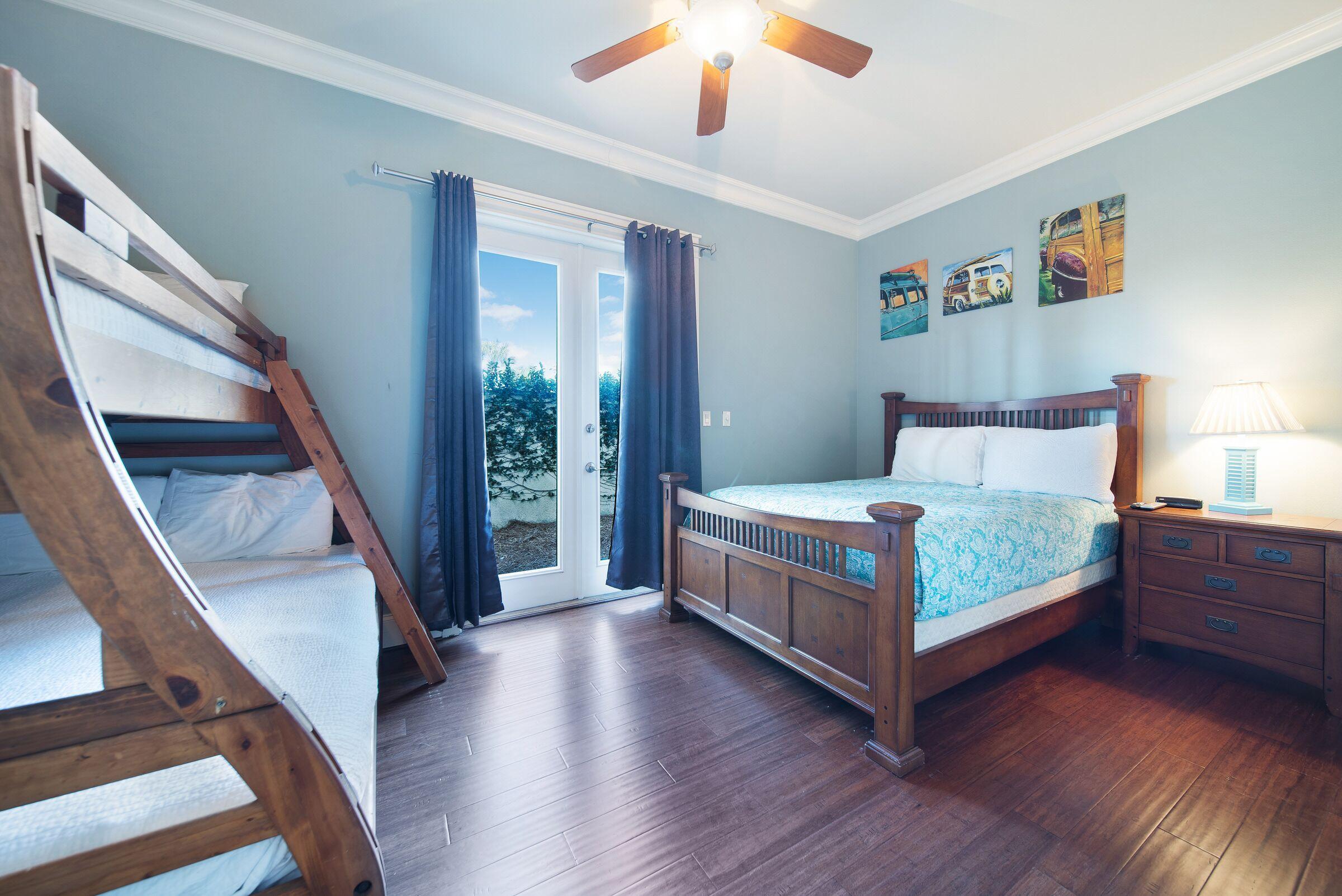 4836 Ocean Boulevard Destin, FL 32541 - Photo 61 of 71 a bedroom with a bed and a chandelier