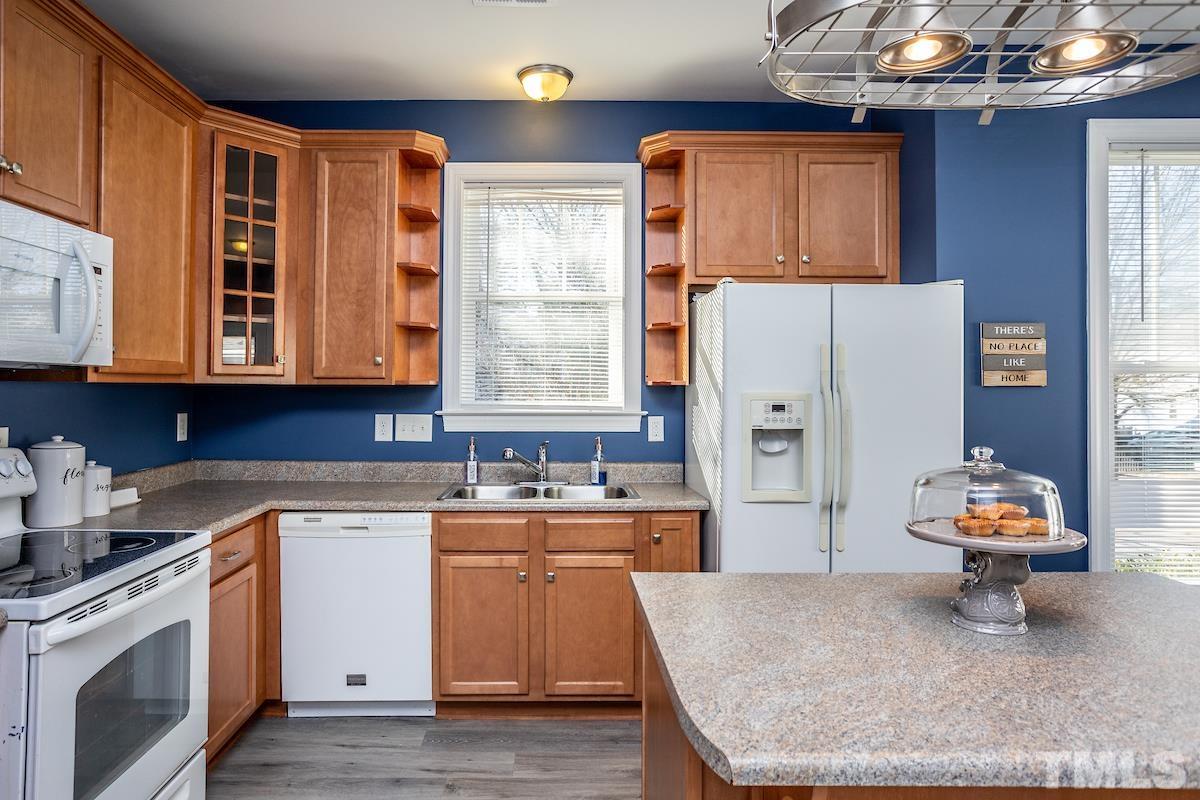 805 East Jones Street Raleigh, NC 27601 - Photo 11 of 24 a kitchen with stainless steel appliances granite countertop a sink dishwasher stove and refrigerator with wooden floor