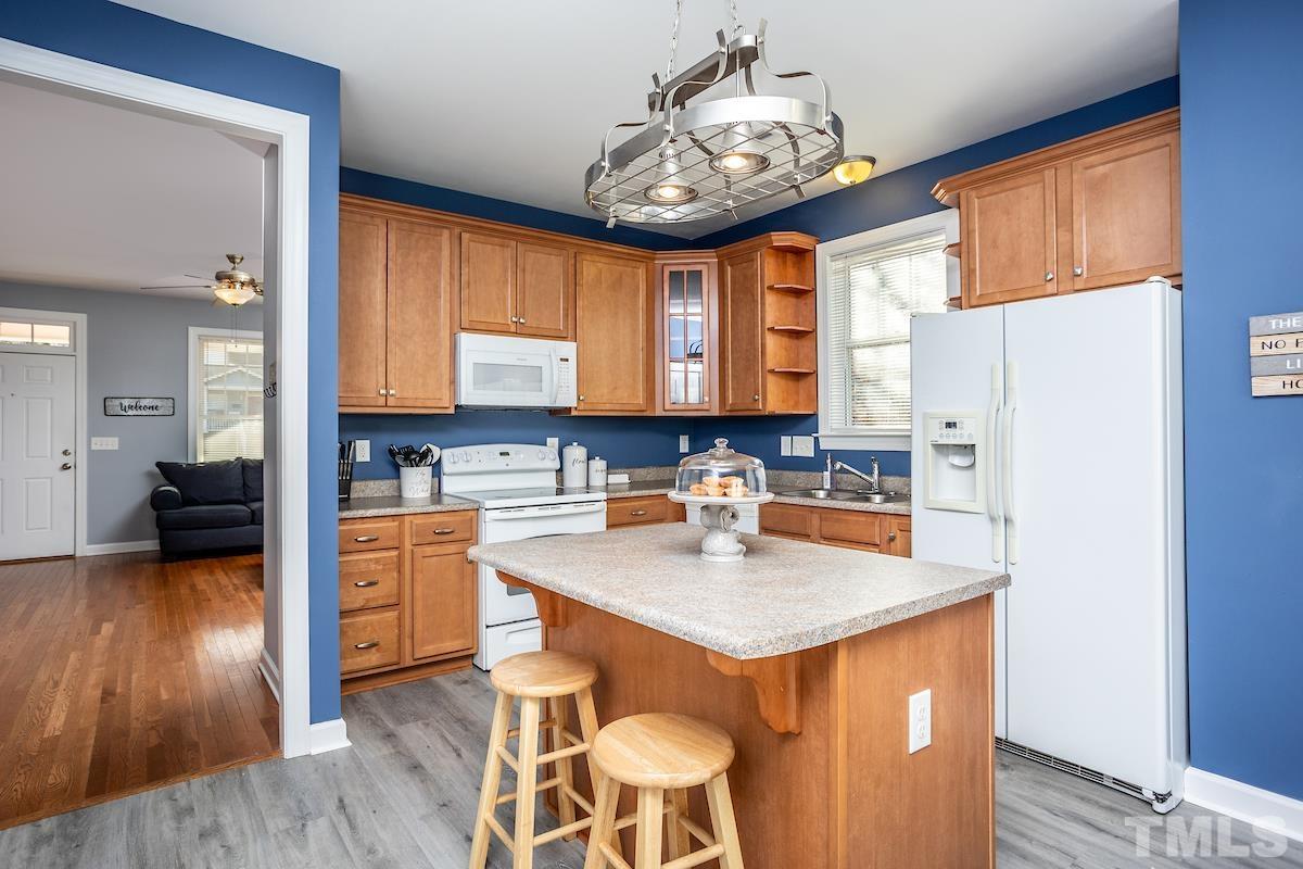 805 East Jones Street Raleigh, NC 27601 - Photo 12 of 24 a kitchen with a refrigerator a stove a sink and dishwasher with wooden floor