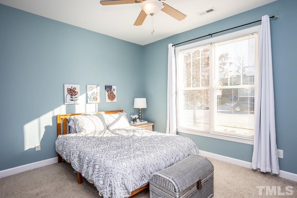 805 East Jones Street Raleigh, NC 27601 - Photo 13 of 24 a bedroom with a large bed and a window