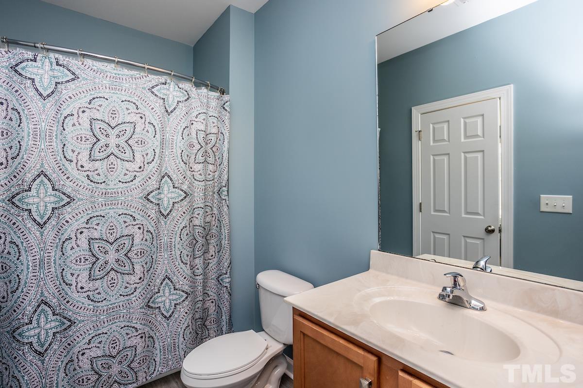 805 East Jones Street Raleigh, NC 27601 - Photo 15 of 24 a bathroom with a sink and mirror with toilet