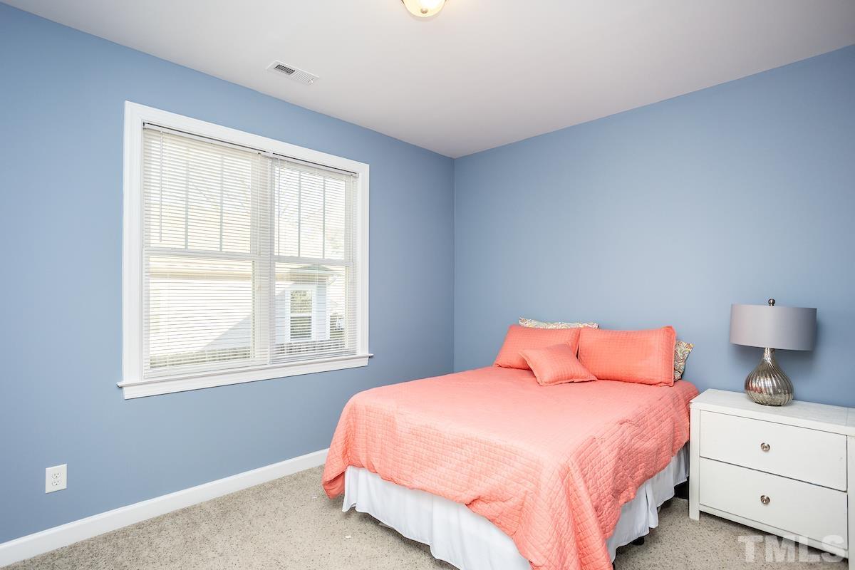 805 East Jones Street Raleigh, NC 27601 - Photo 16 of 24 a bedroom with a bed and window