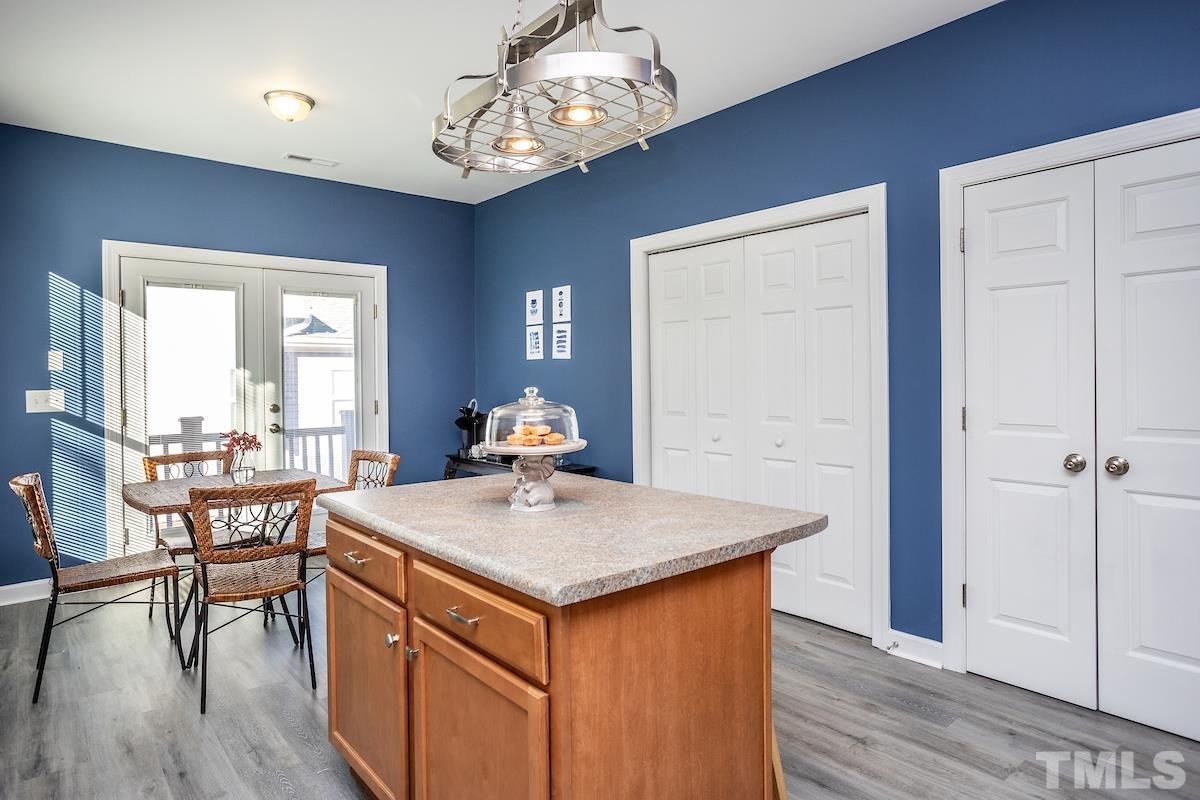 805 East Jones Street Raleigh, NC 27601 - Photo 8 of 24 a view of a kitchen area with furniture and wooden floor