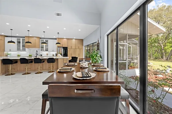 a kitchen with stainless steel appliances granite countertop a sink and a refrigerator