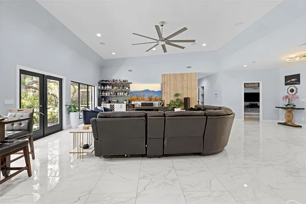 a view of a kitchen with kitchen island stainless steel appliances refrigerator stove microwave and cabinets