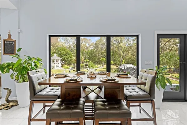 an aerial view of residential house with outdoor space and trees all around
