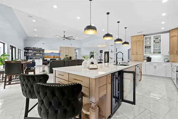 a living room with furniture a chandelier and a flat screen tv