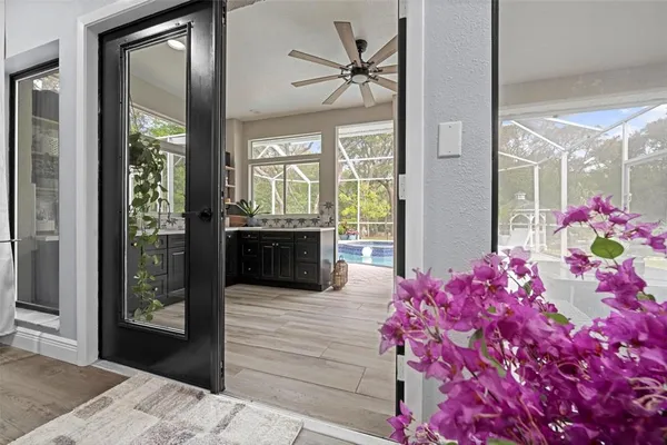 a bathroom with a tub sink and large window