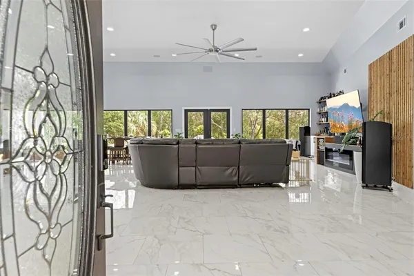 a living room with furniture and kitchen view