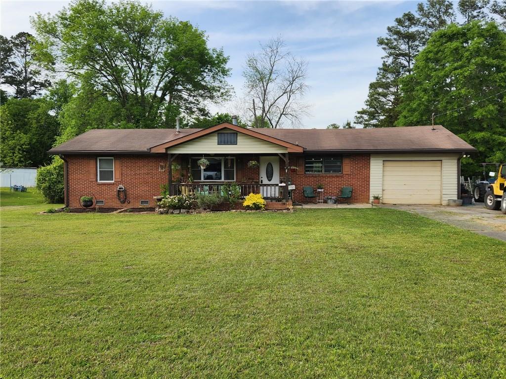 29 Johns Drive Northeast Rome, GA 30165 - Photo 1 of 32 a front view of a house with garden