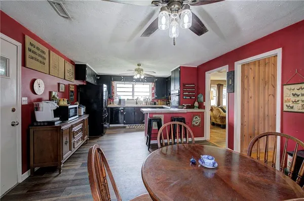 a living room with stainless steel appliances kitchen island granite countertop furniture and a flat screen tv