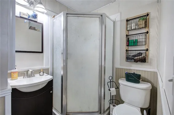 a bathroom with a toilet a sink and mirror