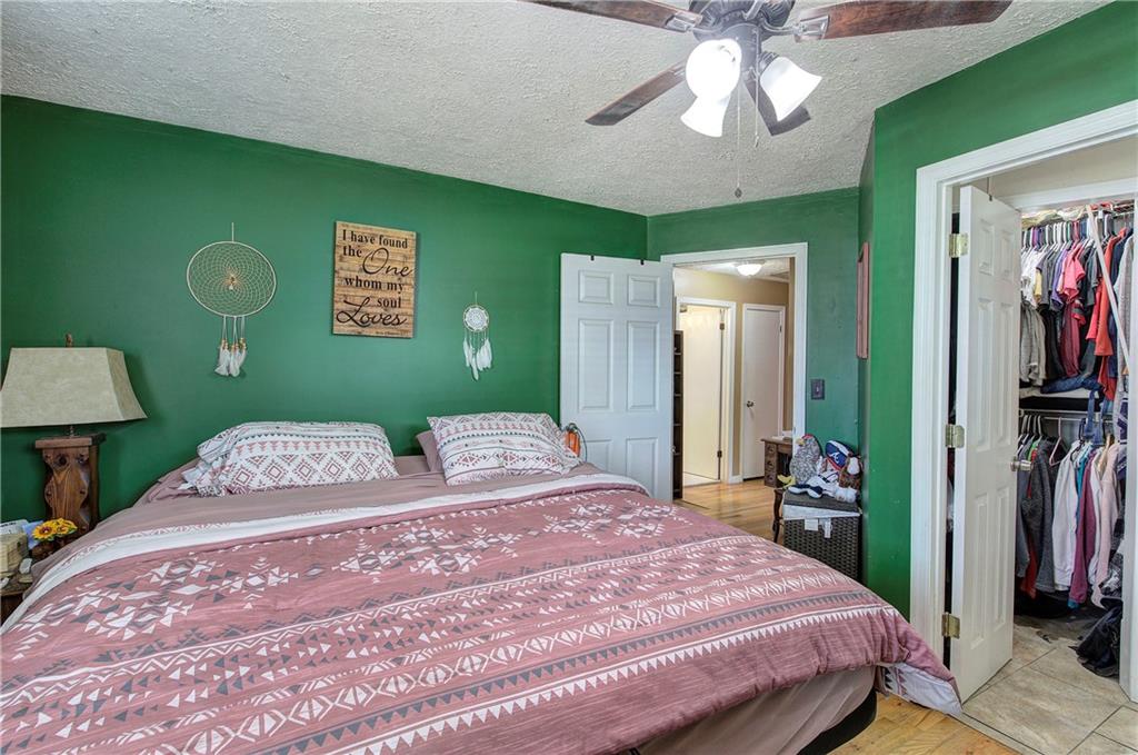 29 Johns Drive Northeast Rome, GA 30165 - Photo 18 of 32 a bedroom with a bed and a chandelier