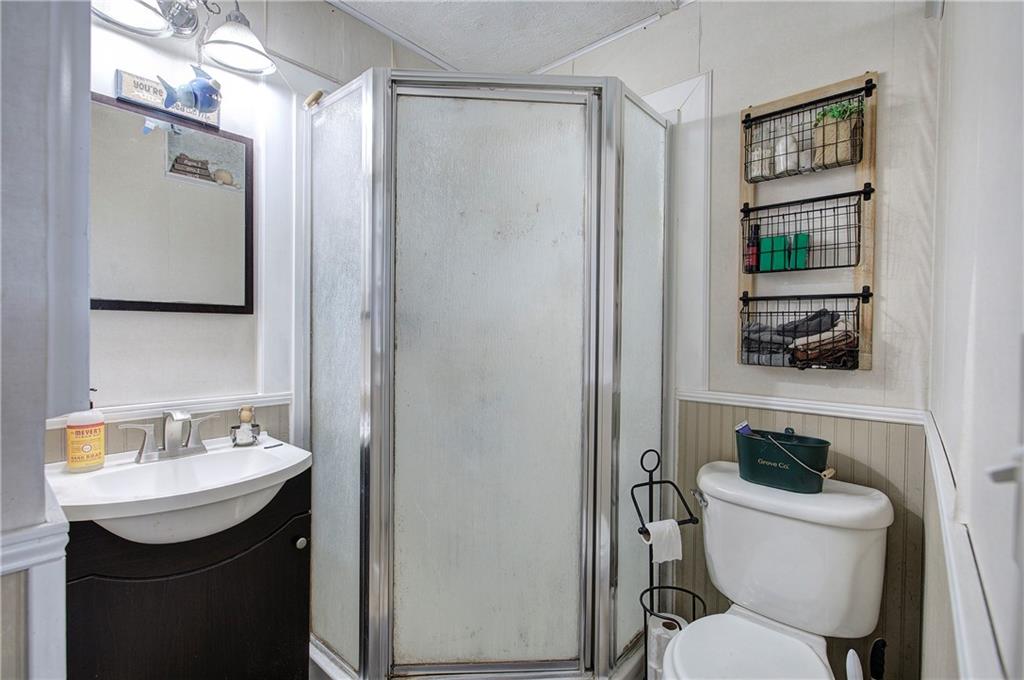 29 Johns Drive Northeast Rome, GA 30165 - Photo 19 of 32 a bathroom with a toilet a sink and mirror