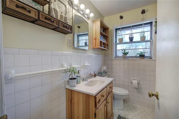 a bathroom with a sink a toilet and mirror