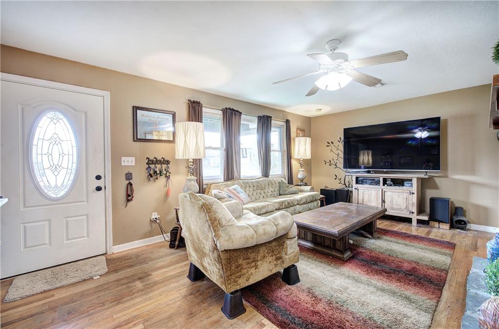 29 Johns Drive Northeast Rome, GA 30165 - Photo 8 of 32 a living room with furniture a flat screen tv and a window