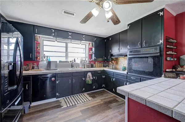 a kitchen with a sink a stove and cabinets