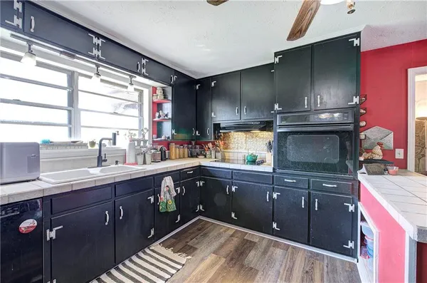 a kitchen with a sink and wooden cabinets
