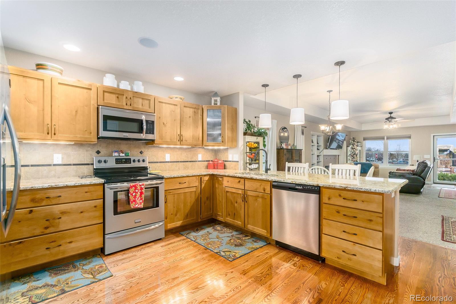 2151 Redhead Drive Johnstown, CO 80534 - Photo 13 of 37 a kitchen with stainless steel appliances granite countertop a stove and a sink