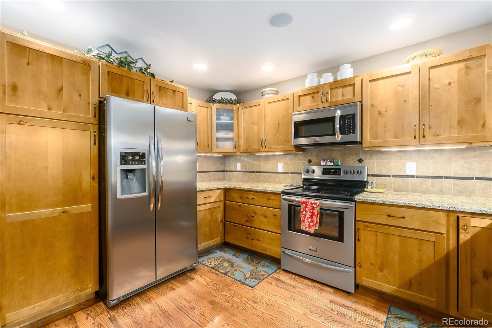 2151 Redhead Drive Johnstown, CO 80534 - Photo 14 of 37 a kitchen with stainless steel appliances granite countertop a refrigerator stove and microwave