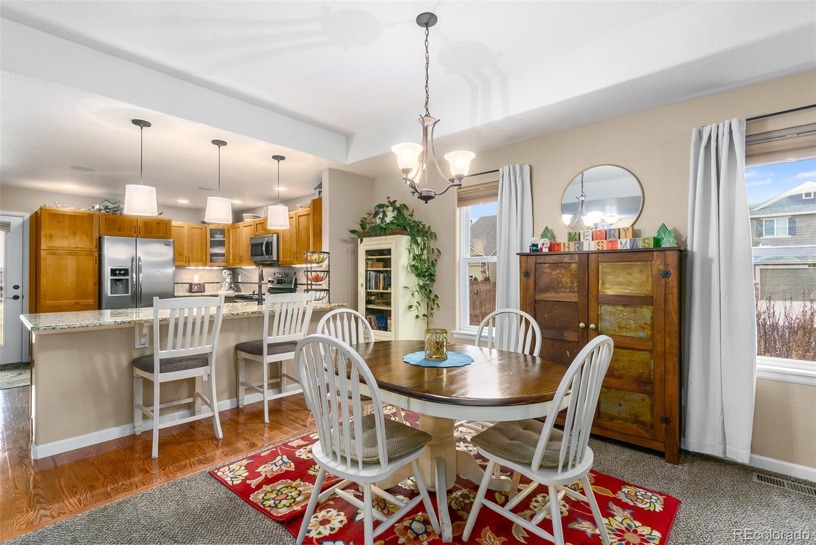 2151 Redhead Drive Johnstown, CO 80534 - Photo 16 of 37 a dining room with furniture a chandelier and wooden floor