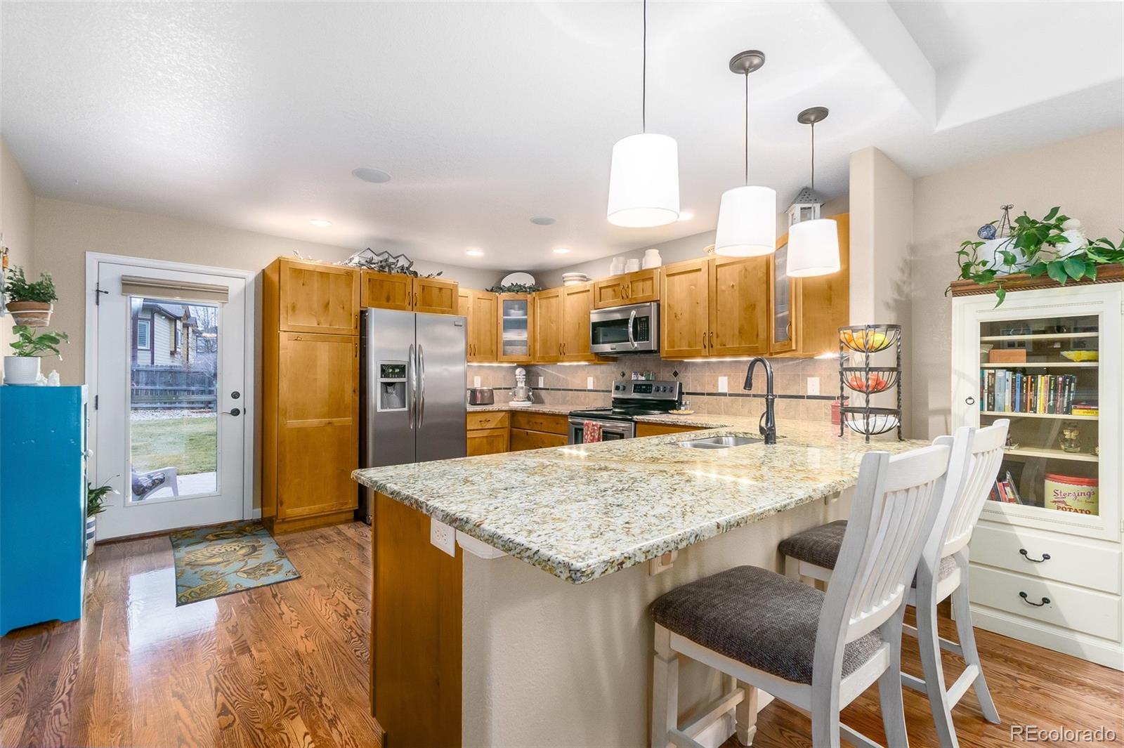 2151 Redhead Drive Johnstown, CO 80534 - Photo 17 of 37 a large kitchen with a table and chairs