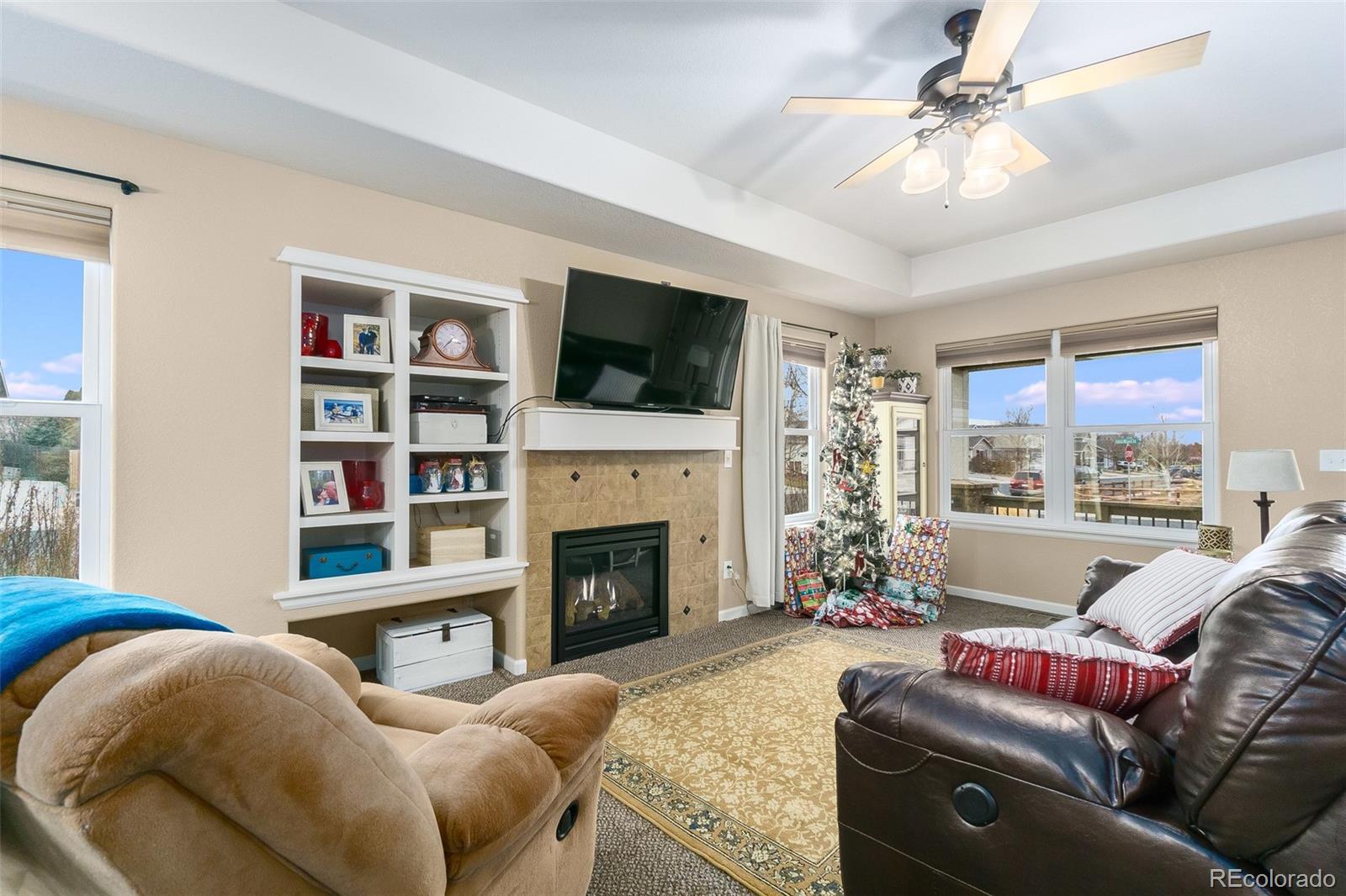 2151 Redhead Drive Johnstown, CO 80534 - Photo 21 of 37 a living room with furniture a flat screen tv and a fireplace
