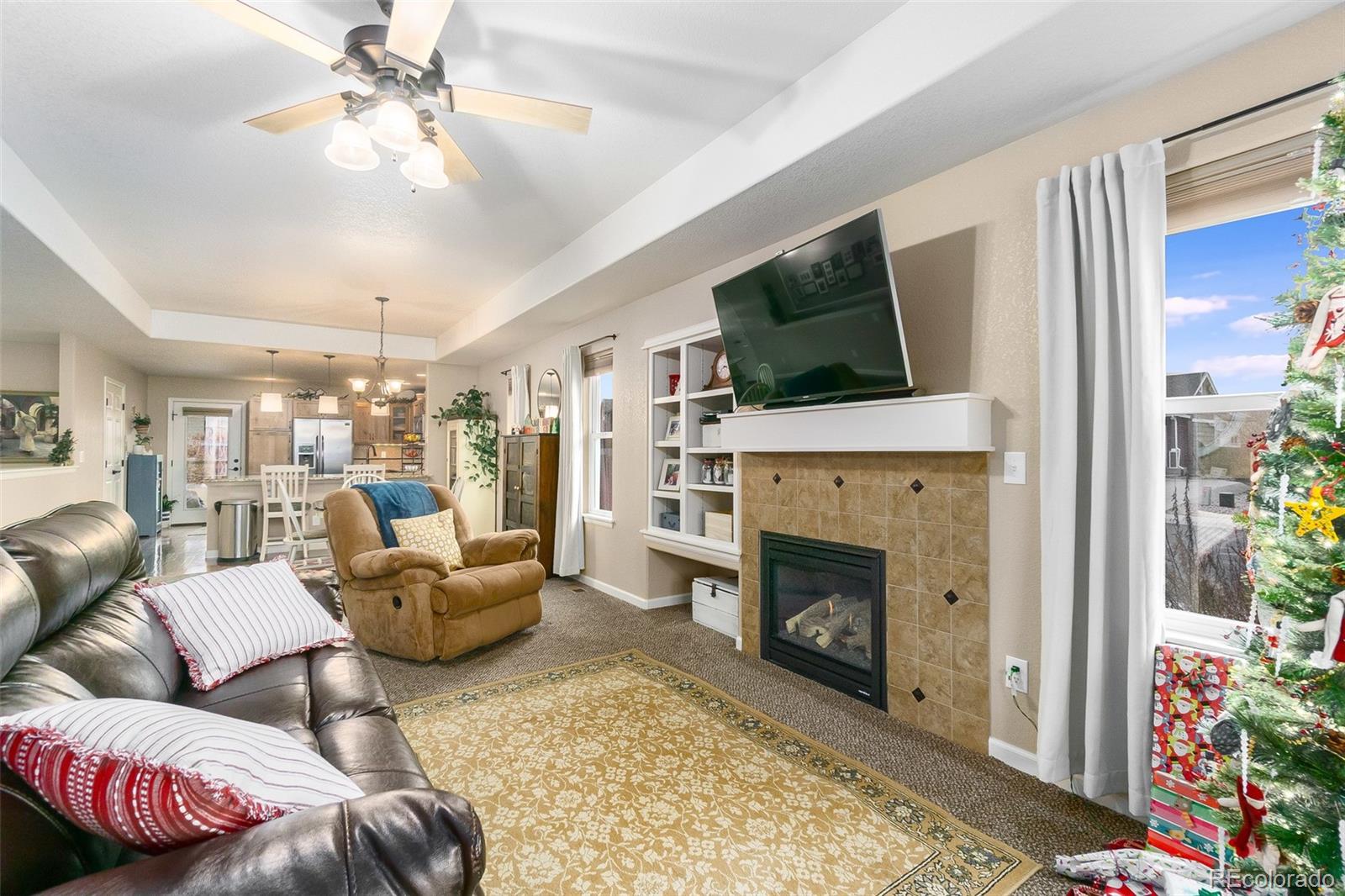 2151 Redhead Drive Johnstown, CO 80534 - Photo 22 of 37 a living room with furniture a flat screen tv and a fireplace