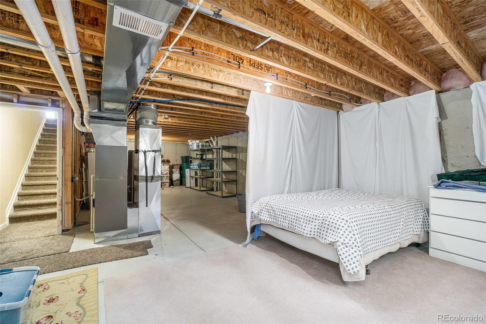 2151 Redhead Drive Johnstown, CO 80534 - Photo 29 of 37 a spacious bedroom with a bed and a walk in closet