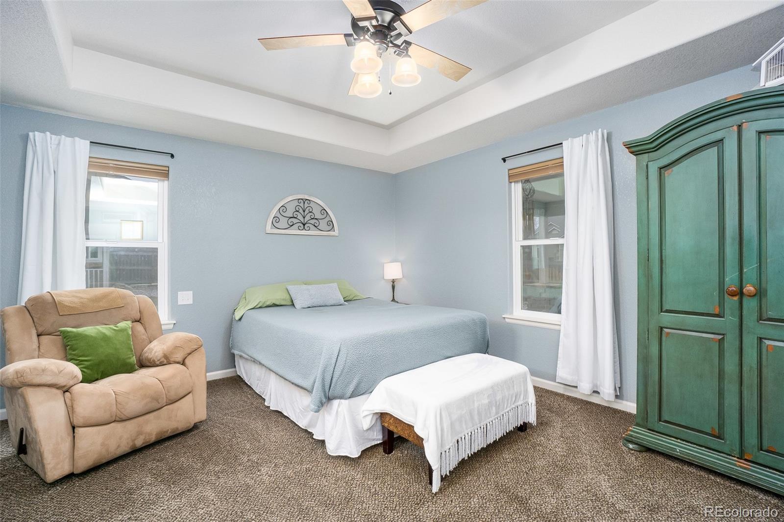 2151 Redhead Drive Johnstown, CO 80534 - Photo 30 of 37 a bedroom with a bed couches and a window