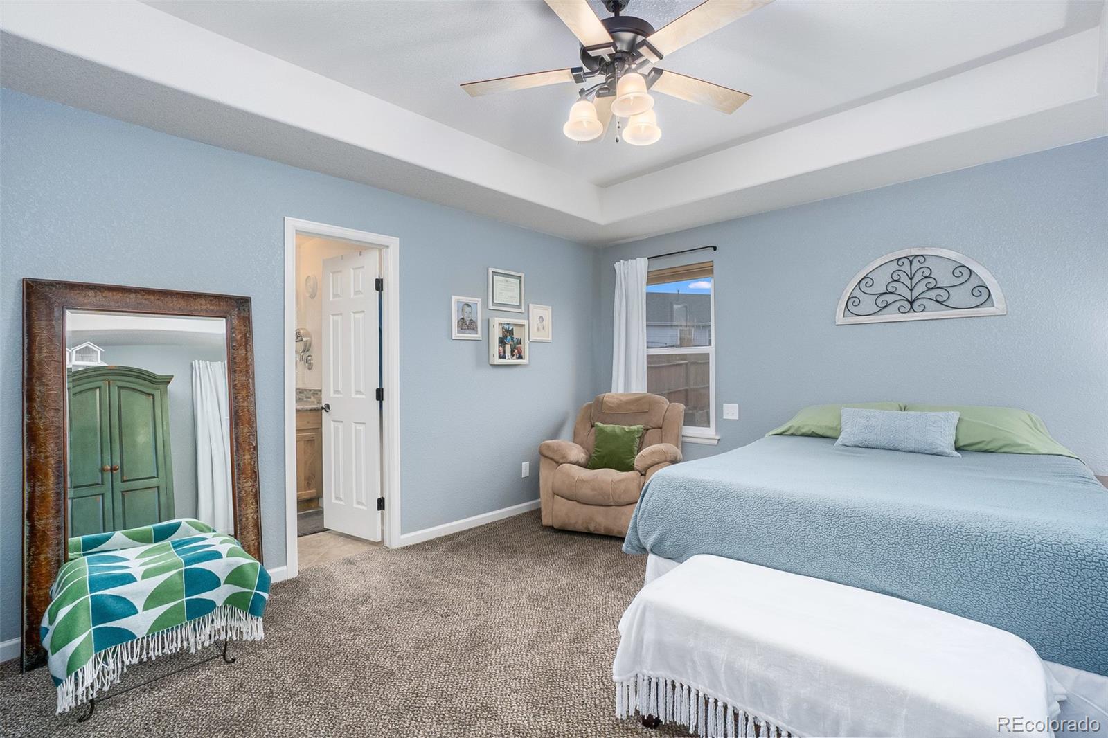 2151 Redhead Drive Johnstown, CO 80534 - Photo 31 of 37 a bedroom with a bed and a chandelier