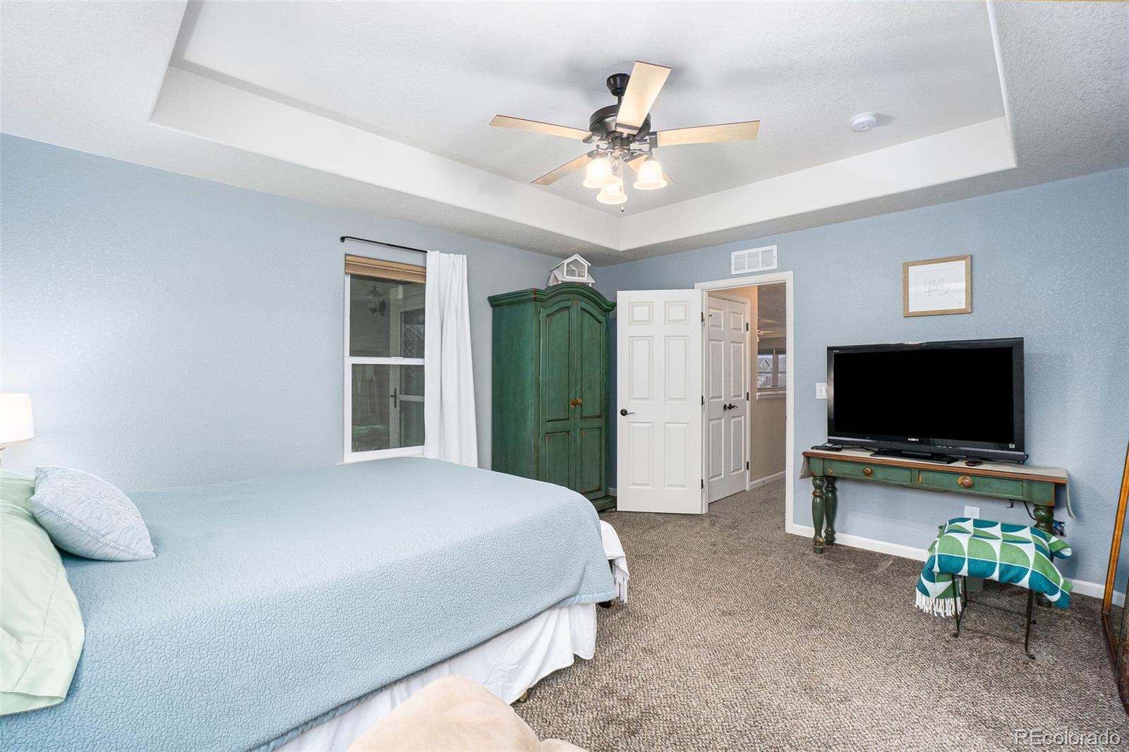 2151 Redhead Drive Johnstown, CO 80534 - Photo 33 of 37 a bedroom with a bed and a flat screen tv