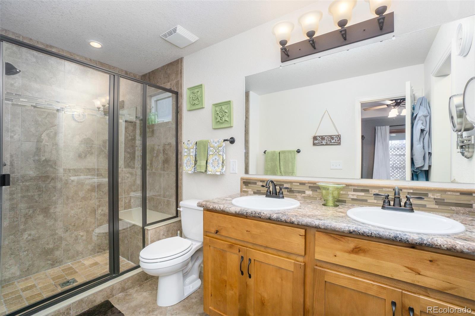 2151 Redhead Drive Johnstown, CO 80534 - Photo 34 of 37 a bathroom with a granite countertop sink toilet and shower