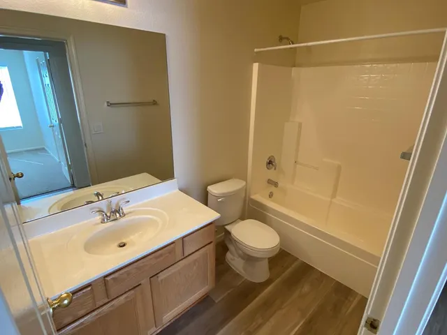 an empty room with closet and a chandelier fan