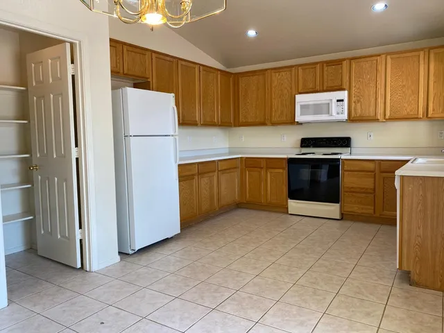 a view of kitchen and kitchen with furniture wooden floor