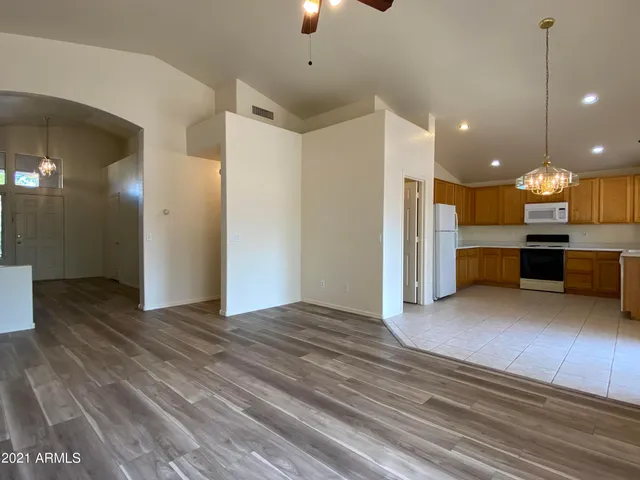 a view of kitchen with furniture and a refrigerator