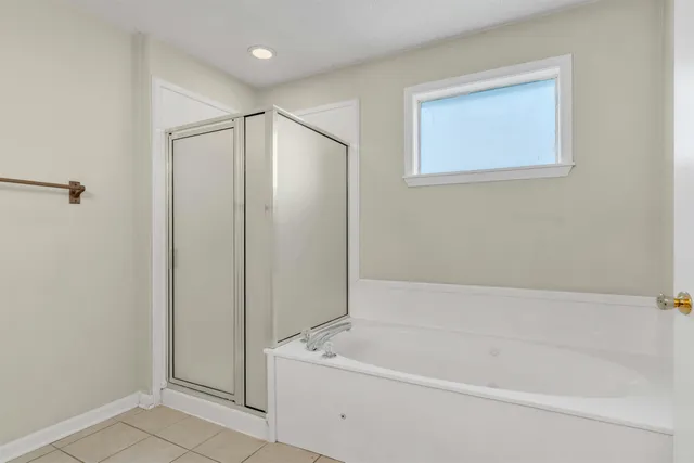 a white bath tub sitting next to a shower