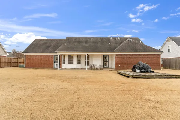 a view of a house with a yard and sitting area