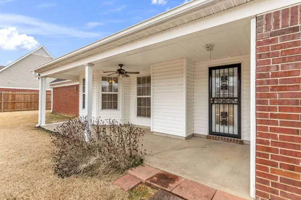 front view of a brick house with a large window