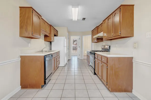 a kitchen with stainless steel appliances granite countertop a stove and a refrigerator