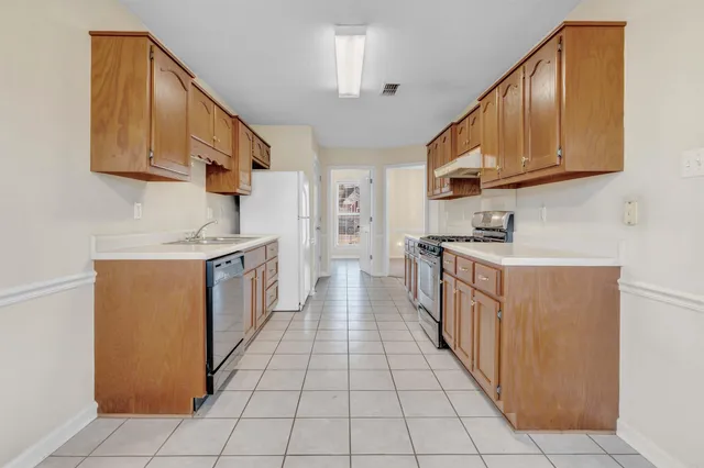 a kitchen with stainless steel appliances granite countertop a stove and a refrigerator