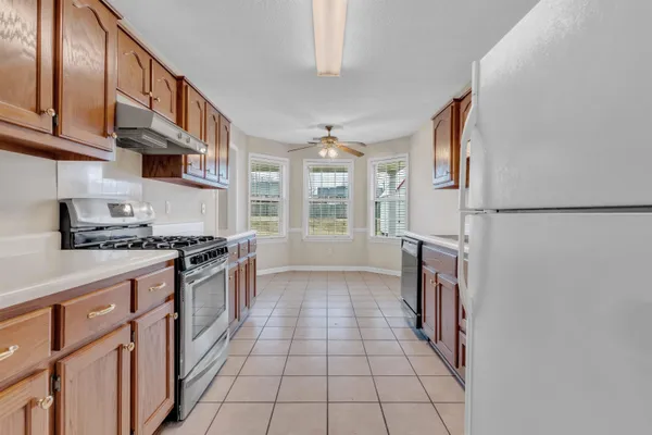a kitchen with stainless steel appliances granite countertop a stove and a refrigerator