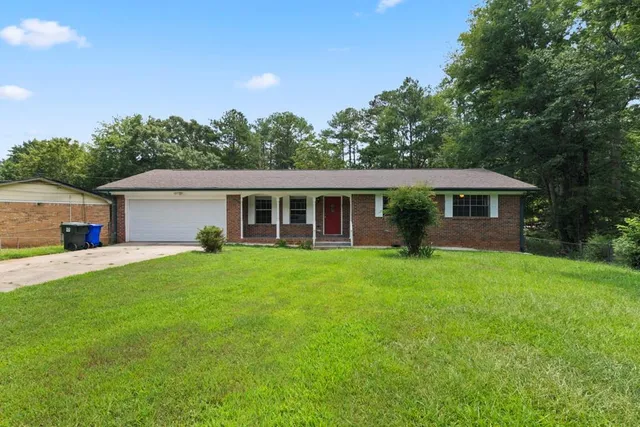 a front view of house with yard and green space