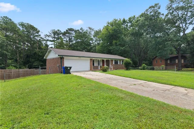 a front view of house with yard and green space