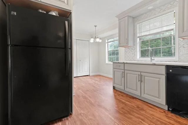 a kitchen with a refrigerator and a sink