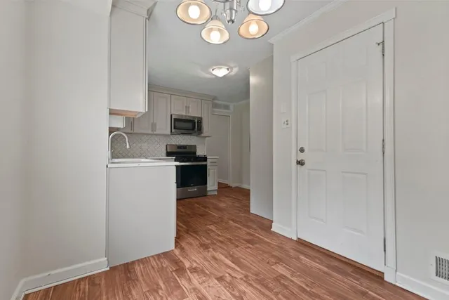a kitchen with cabinets and stainless steel appliances