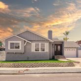 a front view of a house with a garden and plants