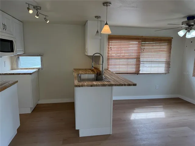 a kitchen with a sink cabinets and window